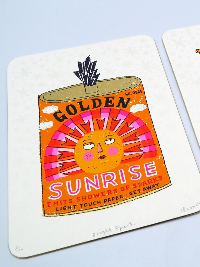 Bright Spark Sun Firework Screenprint, a colourful firework tin design on a white screenprint against a baby blue backdrop. 