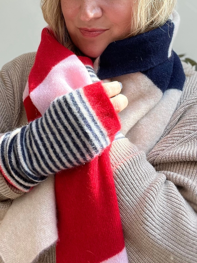 Red pink navy stripe scarf being worn with matching wristwarmers