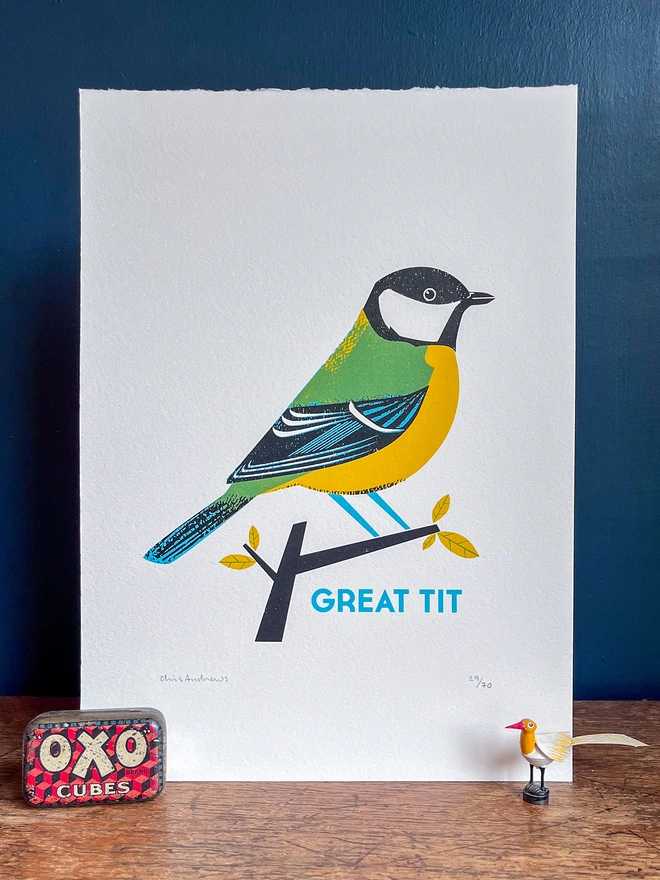 A screenprint of a Great Tit bird on white paper against a navy blue background.