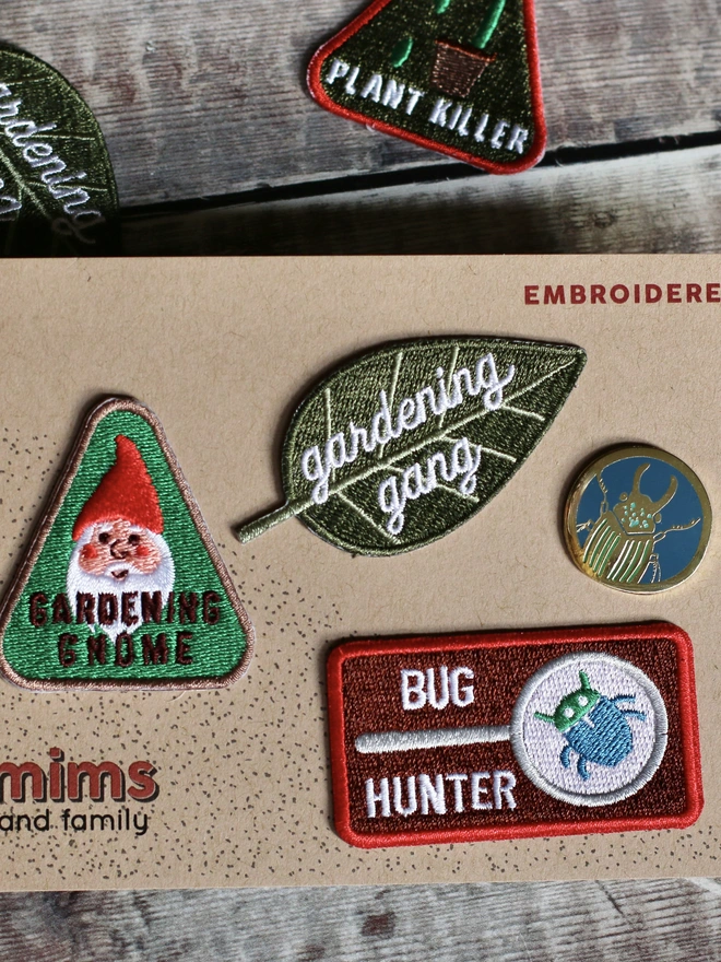 a gardening gang patch, a bug pin, a bug hunter patch, for gardeners