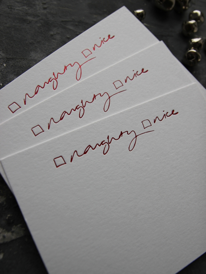 Christmas notecard from Santa that has a tick box for Naughty or Nice in red foil with an envelope that says North Pole Mail