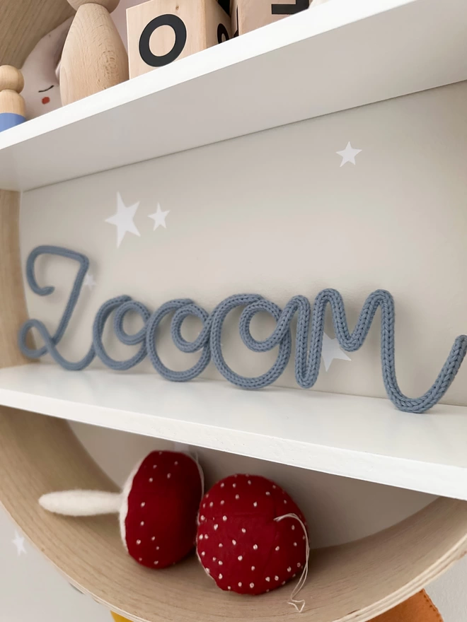 "zoom" sign on a shelf in a child's playroom. 