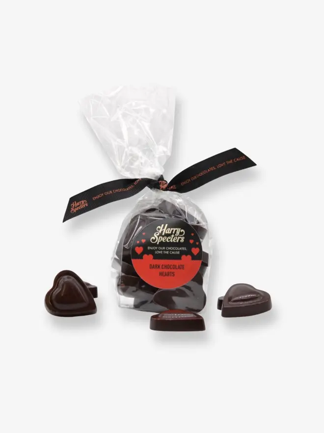 A bag of plant-based luxury dark chocolate hearts tied together with a ribbon