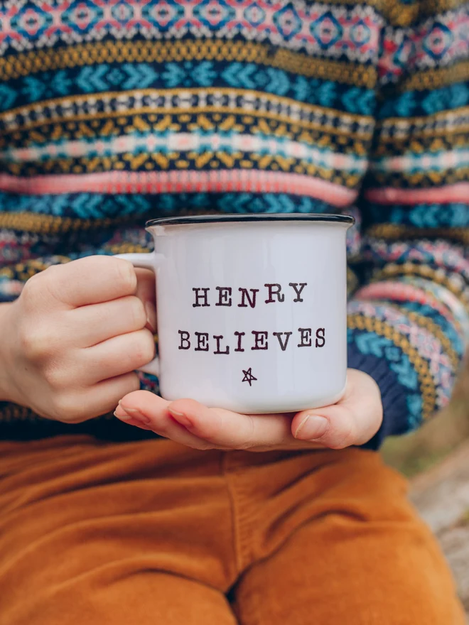 Child holding personalised ceramic christmas mug