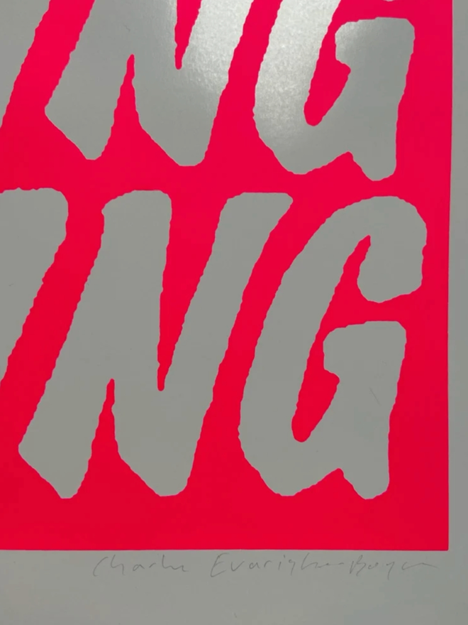 Fluoro Amazing Print. Close up of a print with a vibrant pink background with AMAZING written five times.