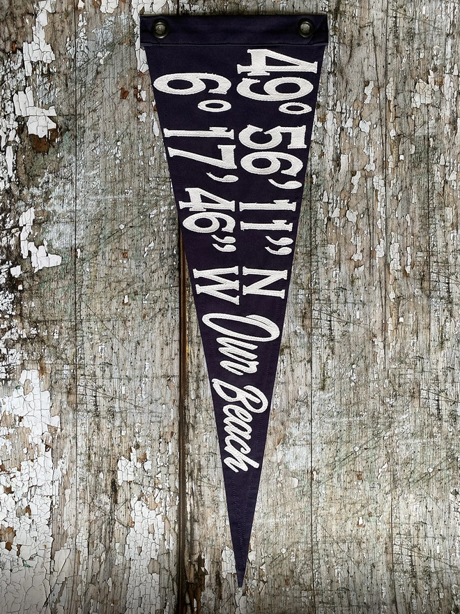 A navy pennant flag with ivory canvas coordinates 