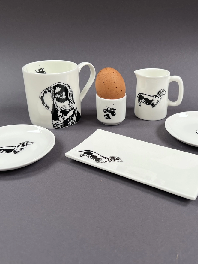 Dachs mug, round and rectangle trinket trays, egg cup with an egg in it and the 1/4 pint jug