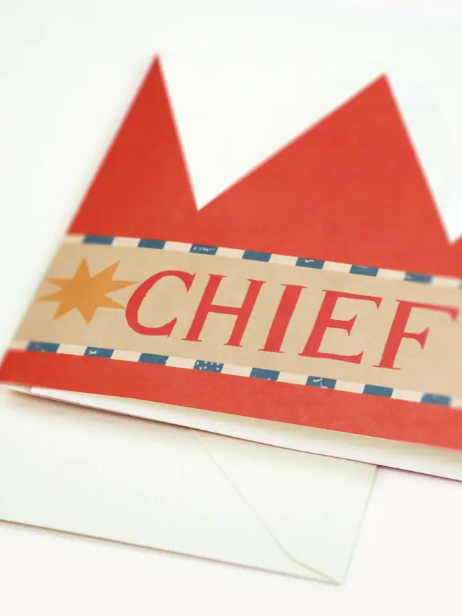 red paper crown card with chief elf text