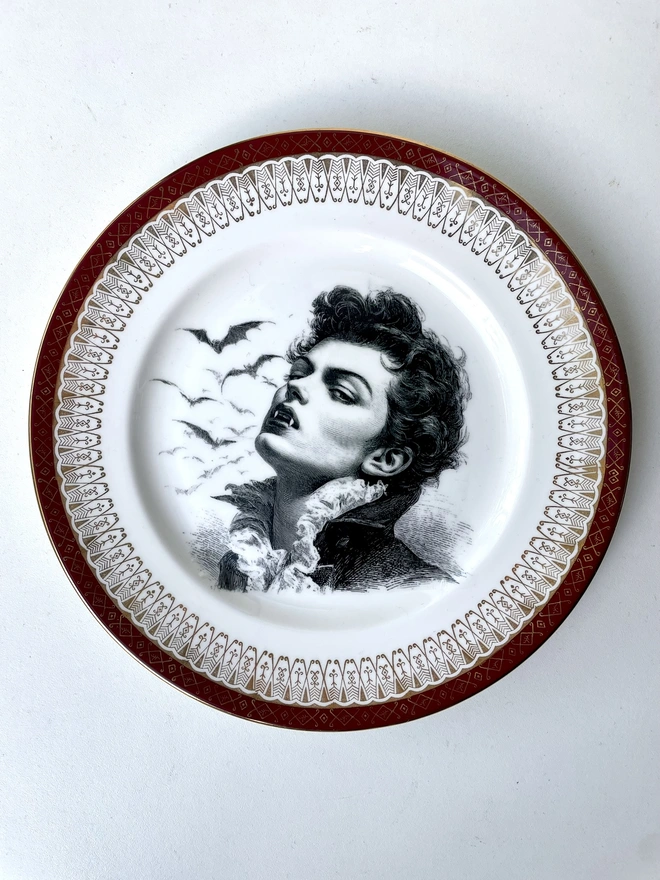 the vampire Louis wtih bats behind him, the image is victorian in black and white and is printed directly onto an ornate vintage plate