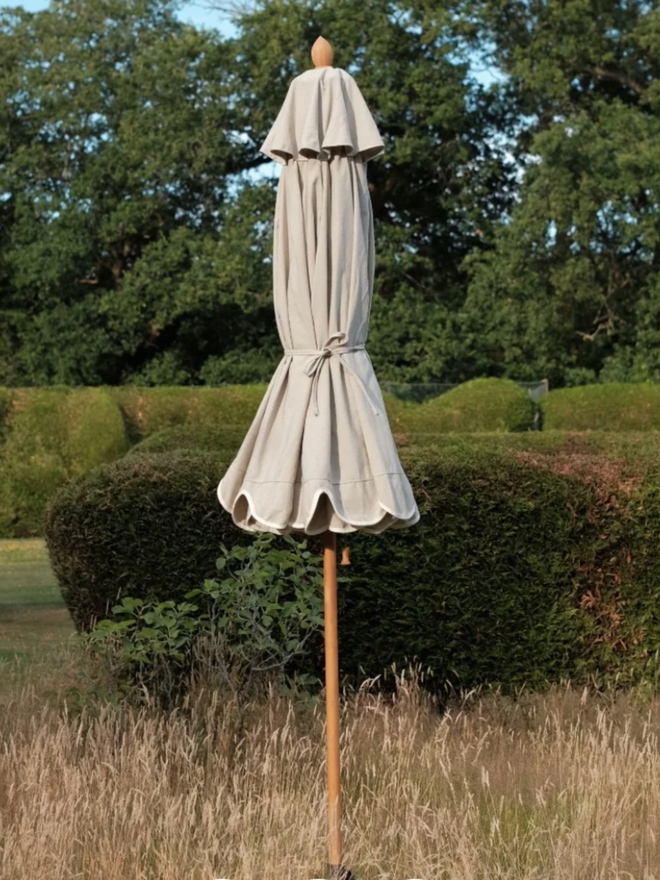 Beige Soft Scallop Parasol. A beige parasol.