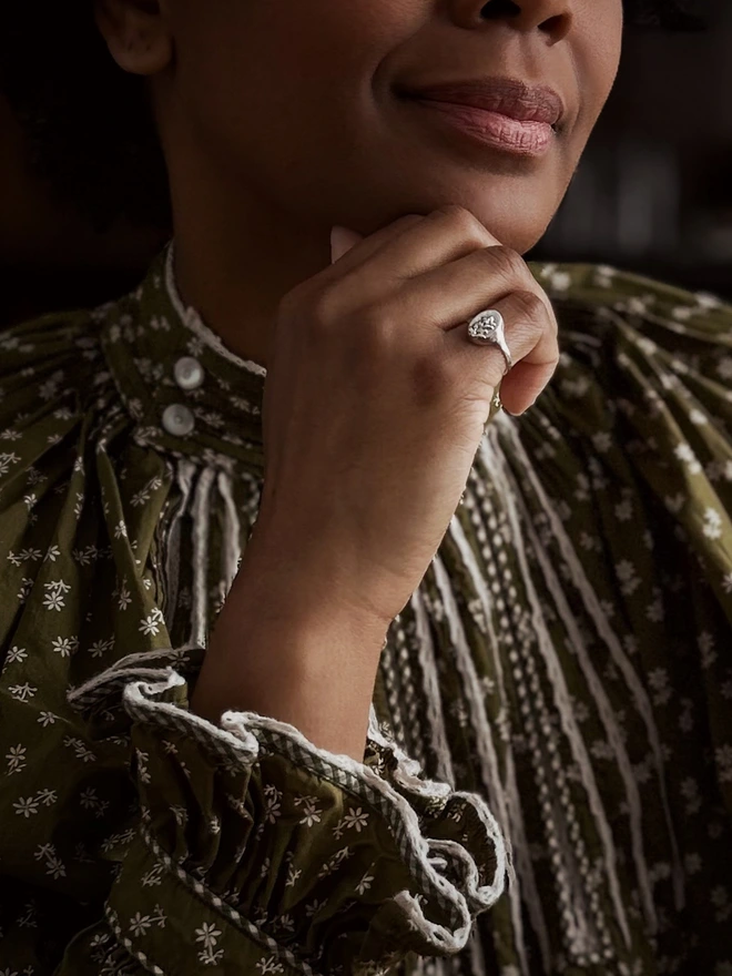 Sterling Silver Signet Ring with a real heather flower cast representing protection in the language of flowers worn by a model