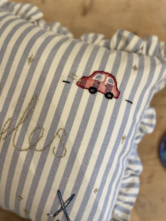 Blue stripe ruffle cushion with hand embroidered details. Personalised design 