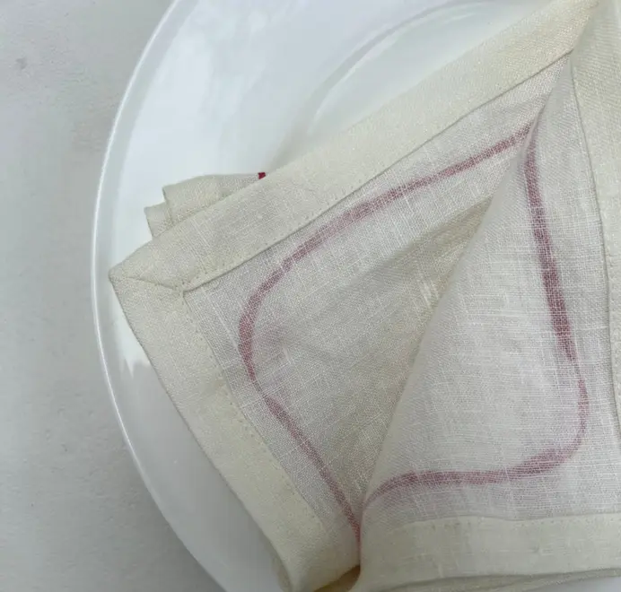 Oak Leaf Napkins (Set of 4). Light cloth napkin, folded on a white plate.