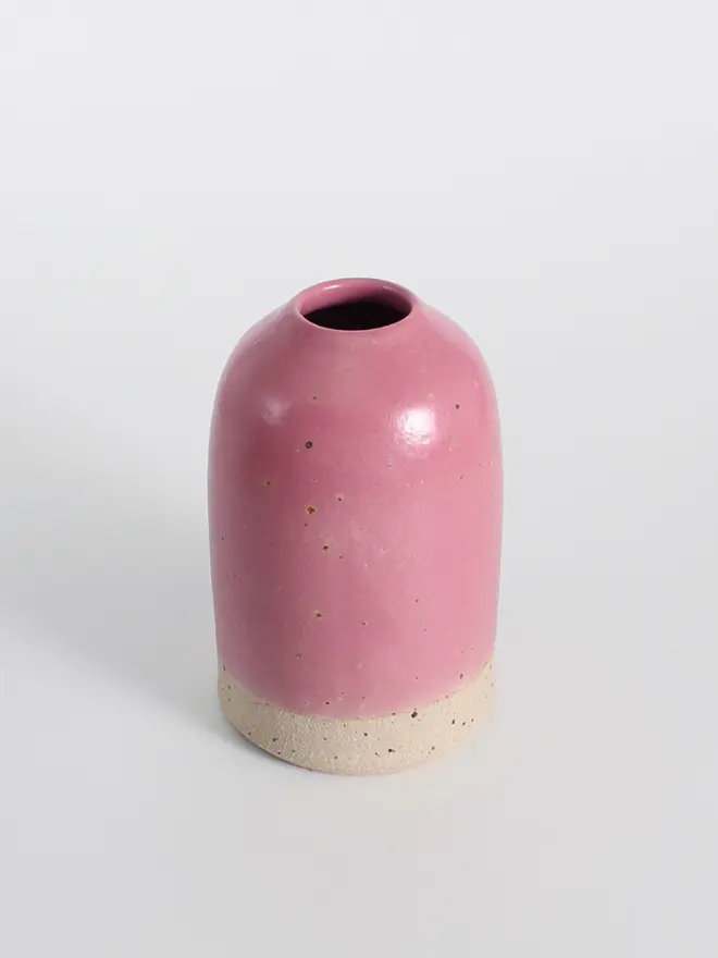 Medium fuchsia ceramic vase against a white background.