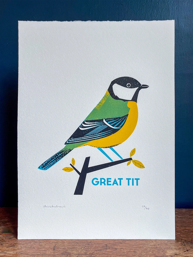 A screenprint of a Great Tit bird on white paper against a navy blue background.