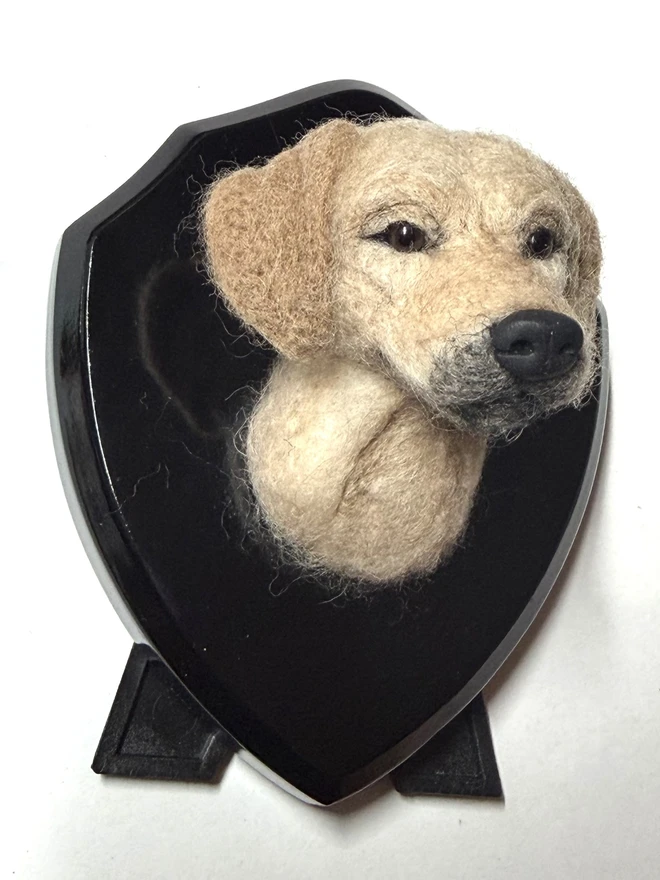 A custom  needle-felted Golden Retriever on a black wooden shield