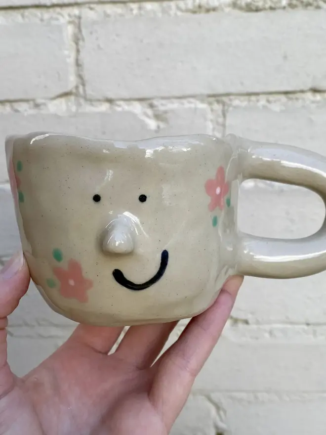 pink flower painted handmade ceramic smiley face mug