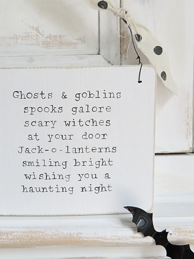 hand painted wooden sign with ghosts and goblins rhyme and spotty ribbon detail