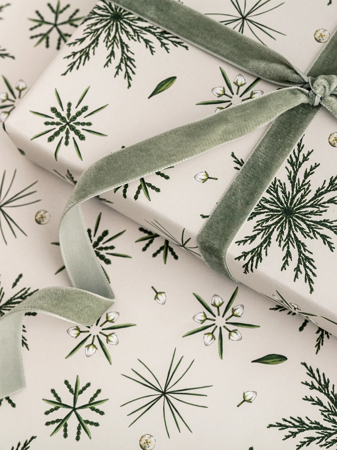 Ivory based christmas wrap with small pine elements making icicle shapes