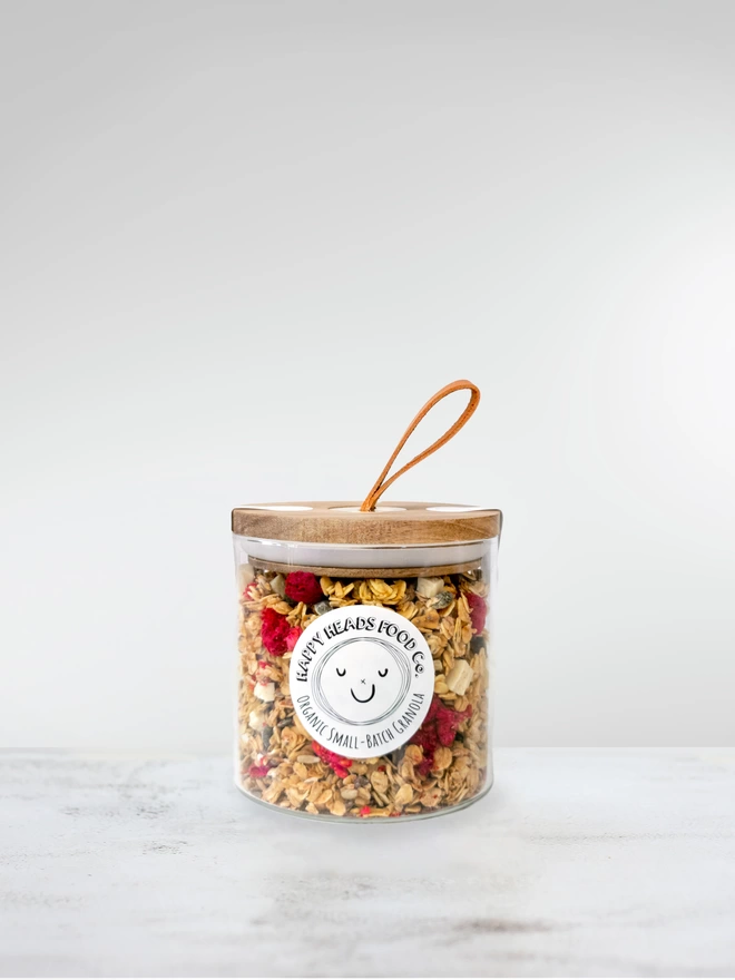 Happy Heads 'Raspberry & White Chocolate' granola in a small (250 g) glass jar 