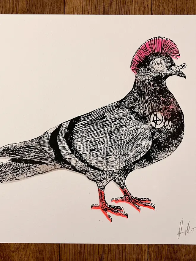Punk pigeon lino print, with symbols, coloured with blue and pink paint with on a white background. 