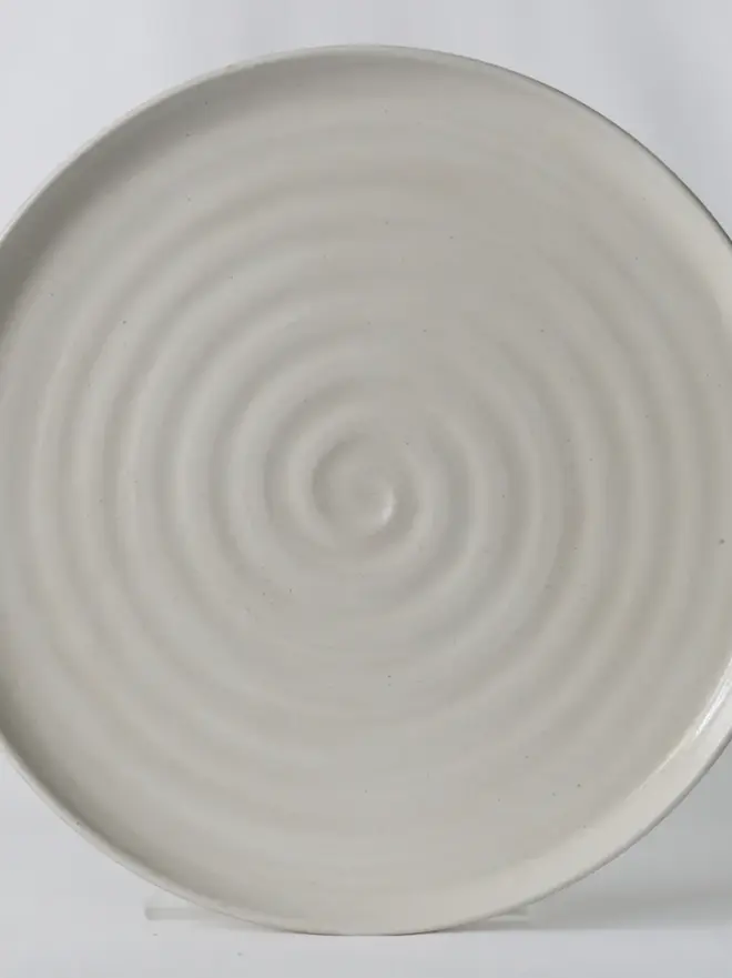 white ceramic plate with textured swirl design