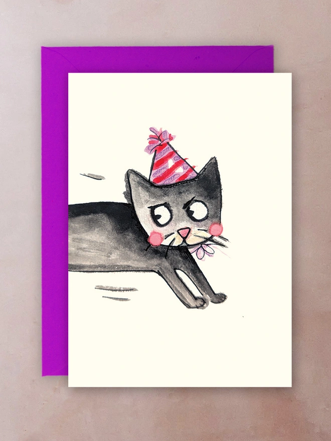 A greetings card with a cat in a party hat.