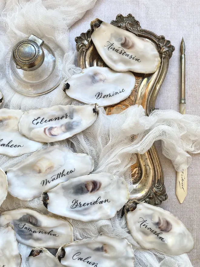 Oyster lid place cards hand written in ink