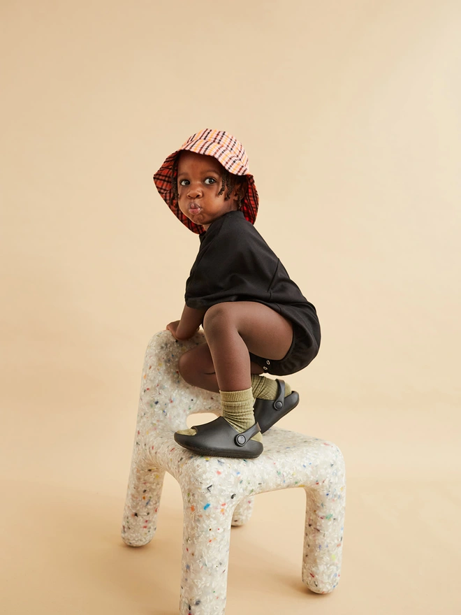 cool unisex kids clothing styled on toddler sat on an ecobirdy kids chair made from recycled plastic