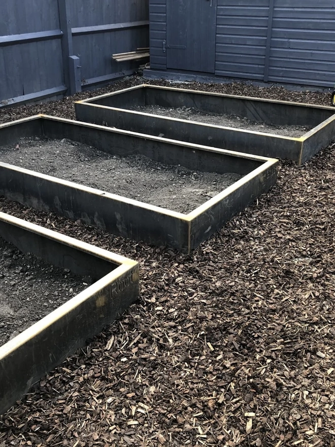 Braybrooke Corten Raised Bed Planters, planter in garden with produce growing. 
