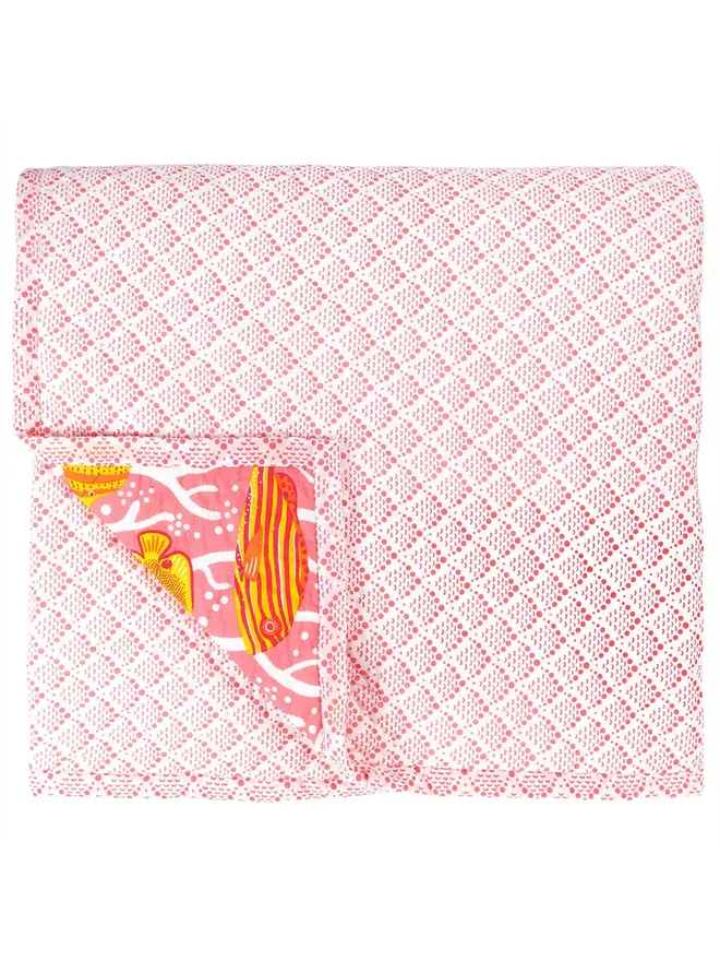 Pink Coral Reef Quilt, a pink reversible cotton quilt with a light pink pattern.