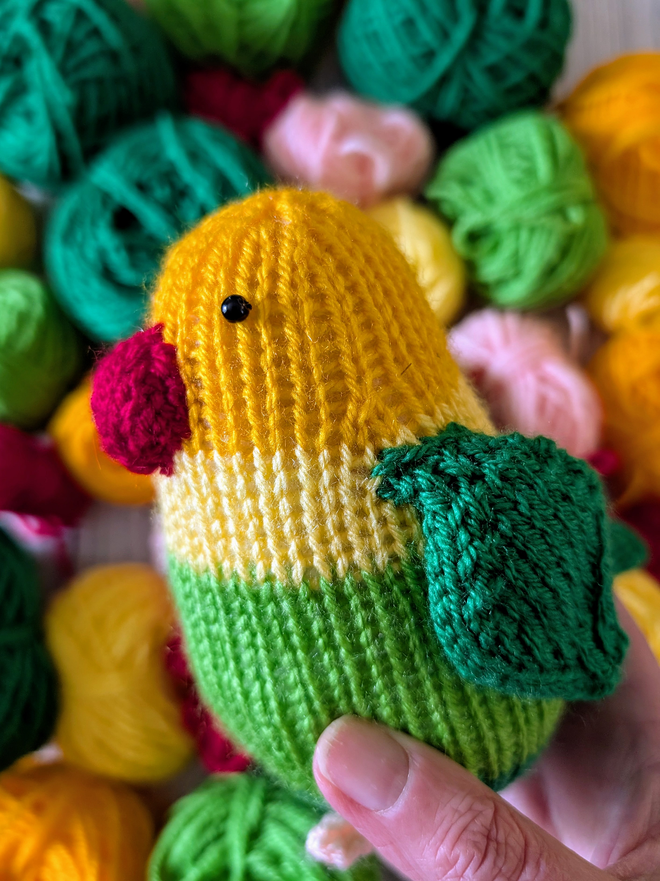 a knitted lovebird with colourful yarn 