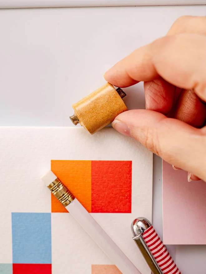 ceramic pastry magnets. a ceramic pain au chocolat magnet on a baking tray.