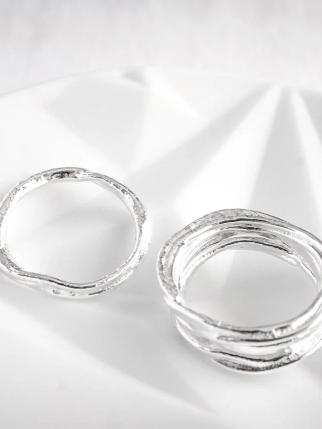 Silver Organic Stacking Ring on a silk material