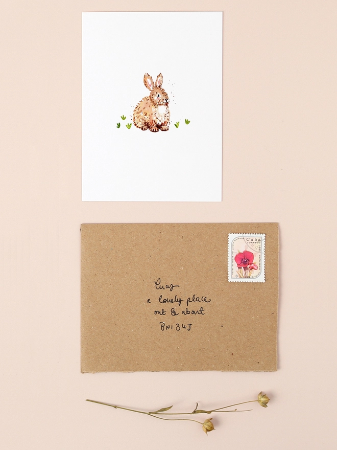 A charming illustration of a soft brown bunny sitting on a patch of green grass, exuding a gentle and serene expression. The bunny's fur is depicted with delicate strokes, highlighting its fluffy texture. The design is minimalist and heartwarming, perfect for conveying a message of kindness or appreciation.