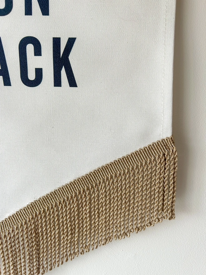 To the Moon and Back fabric printed banner with neutral caramel tassels and gold trim