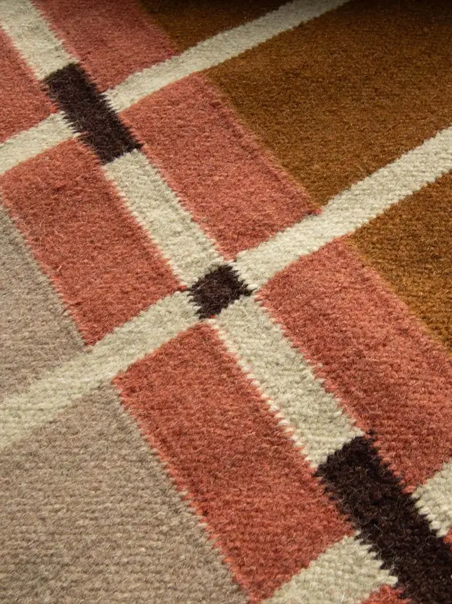 Corbie Flatweave Rug, a colourful rug sitting on a household floor. 