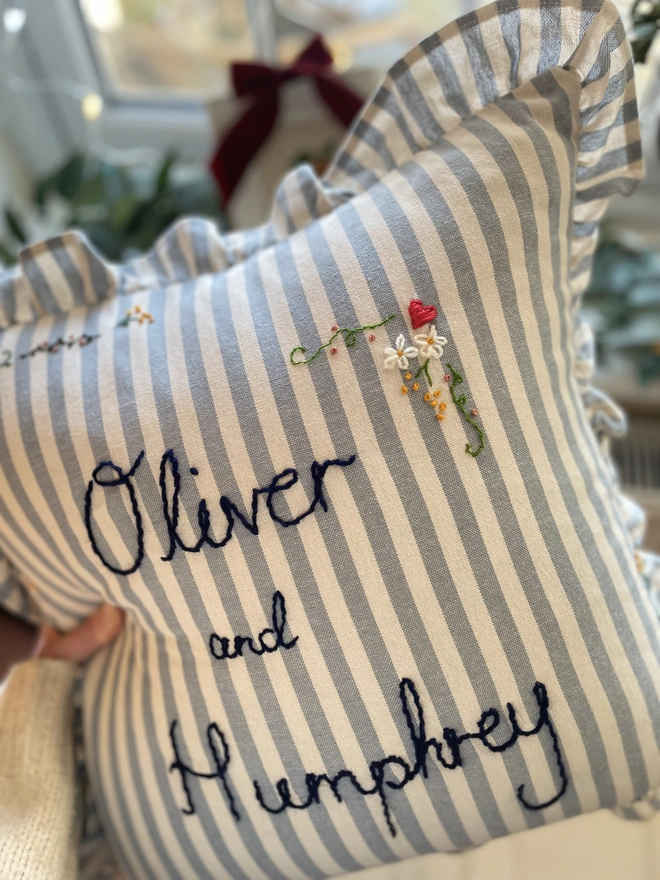 Detailed hand embroidered handmade personalised blue stripe cotton cushion with frill ruffle trim. Valentine’s Day gift. 