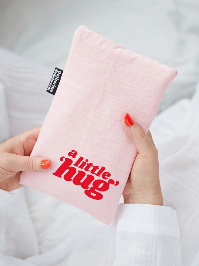 Catherine Colebrook pink linen cute hot water bottle with red 'a little hug' text