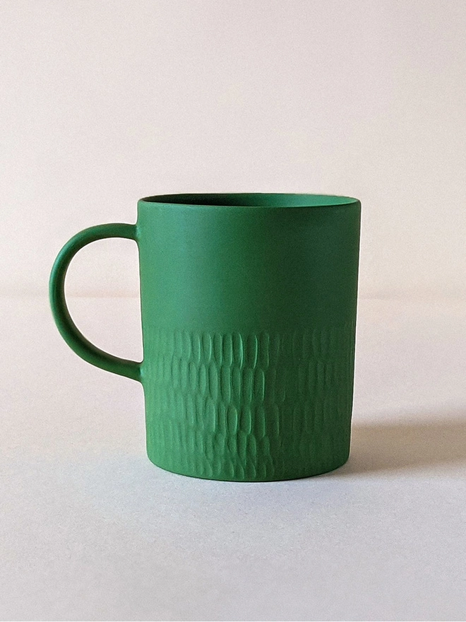 Large Morning Tea Mug made of porcelain in a Dark Angelica Green with hand carved scalloped texture.