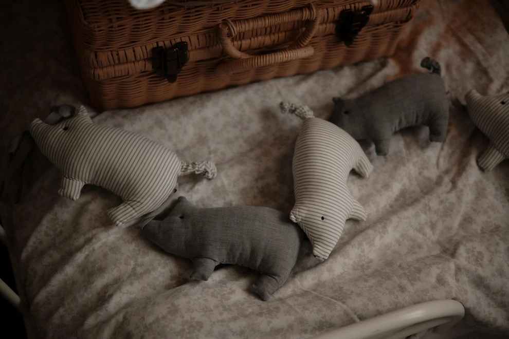 Pig Garland Decoration, a grey and white pig garland decoration in a child's bedroom. It is accompanied by other bedroom accessories. 