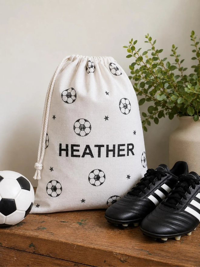 personalised football bag. a drawstring bag with printed footballs and a personalised name.