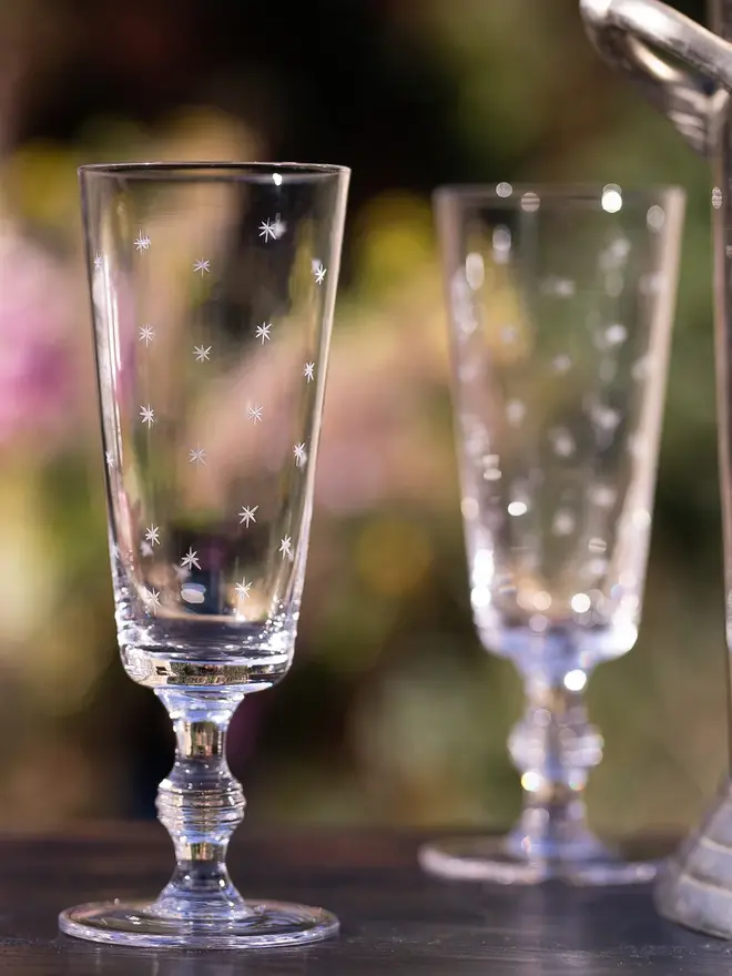 engraved stars champagne flutes (set of 4). champagne glasses patterned with small stars.