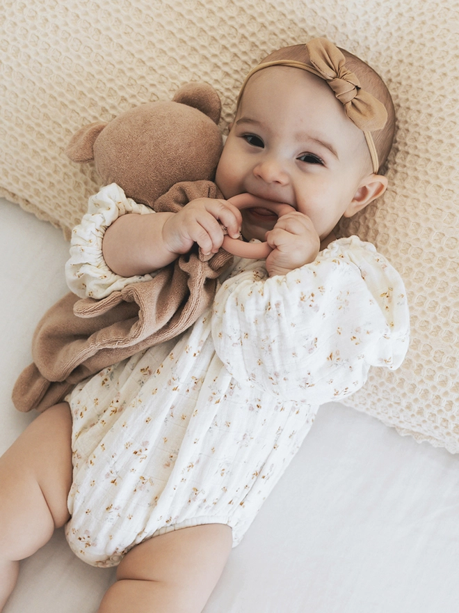 Baby with teething teddy toy