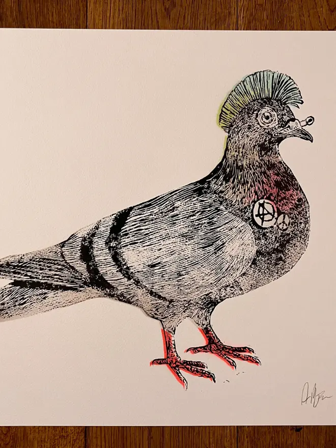 Punk pigeon lino print, with symbols, coloured with blue and pink paint with on a white background. 