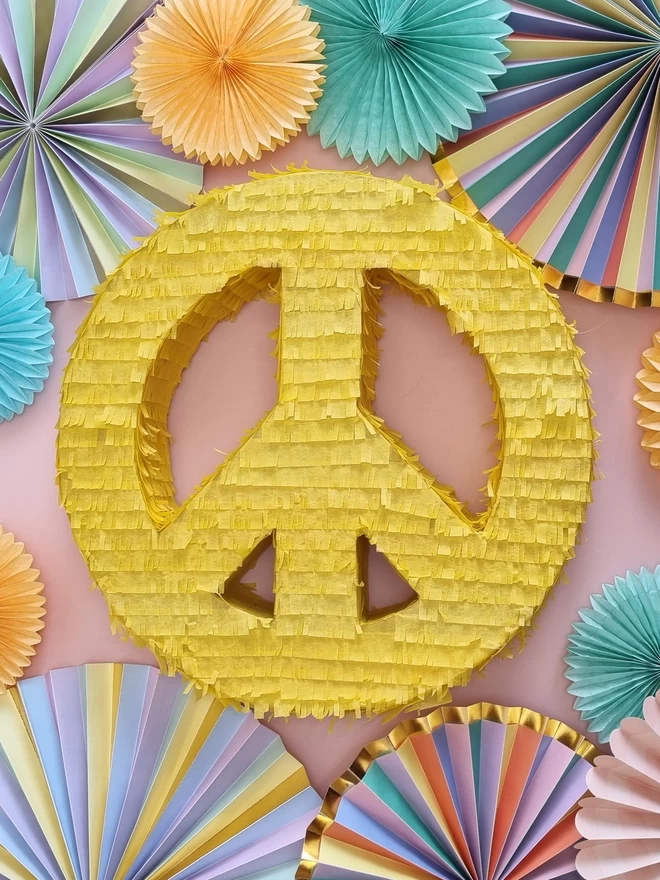 mellow yellow peace sign pinata on a pastel background