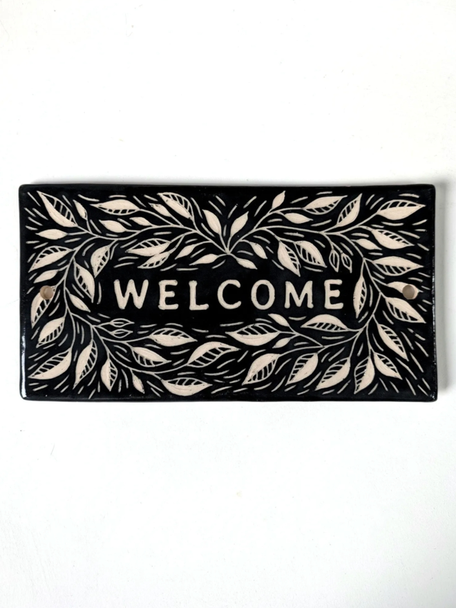 Handmade Ceramic House Plaque with Leaves. A house plaque in black.