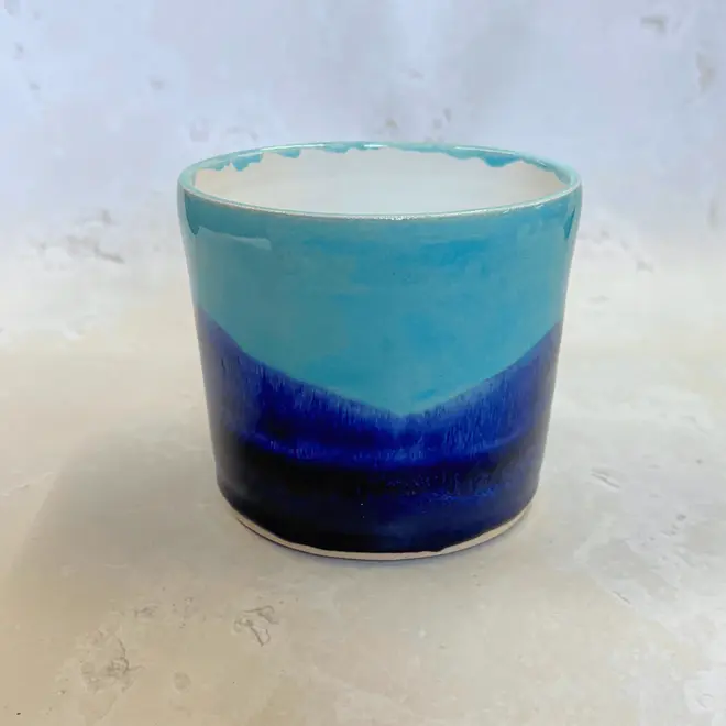 Landscape Medium Pot, a colourful pot on a stone surface.