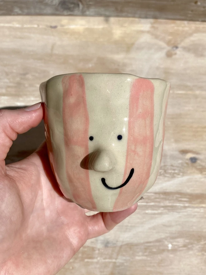 pink stripe pot - held