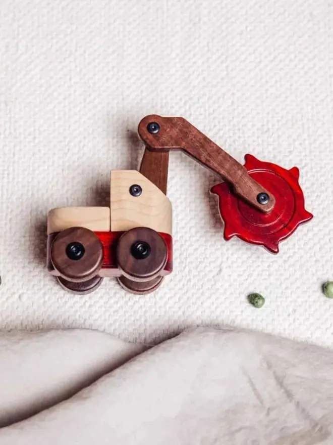 Walnut & Padauk Digger Wood Heirloom Toy, on a table. 